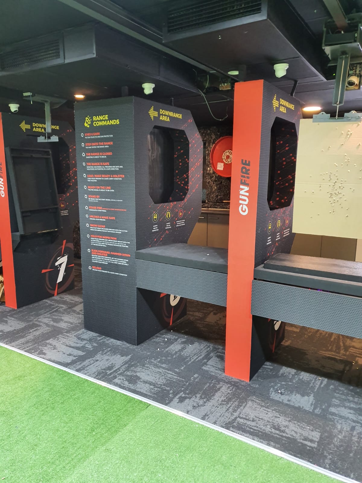 GUNFIRE range bays with the range commands board and shooting bench