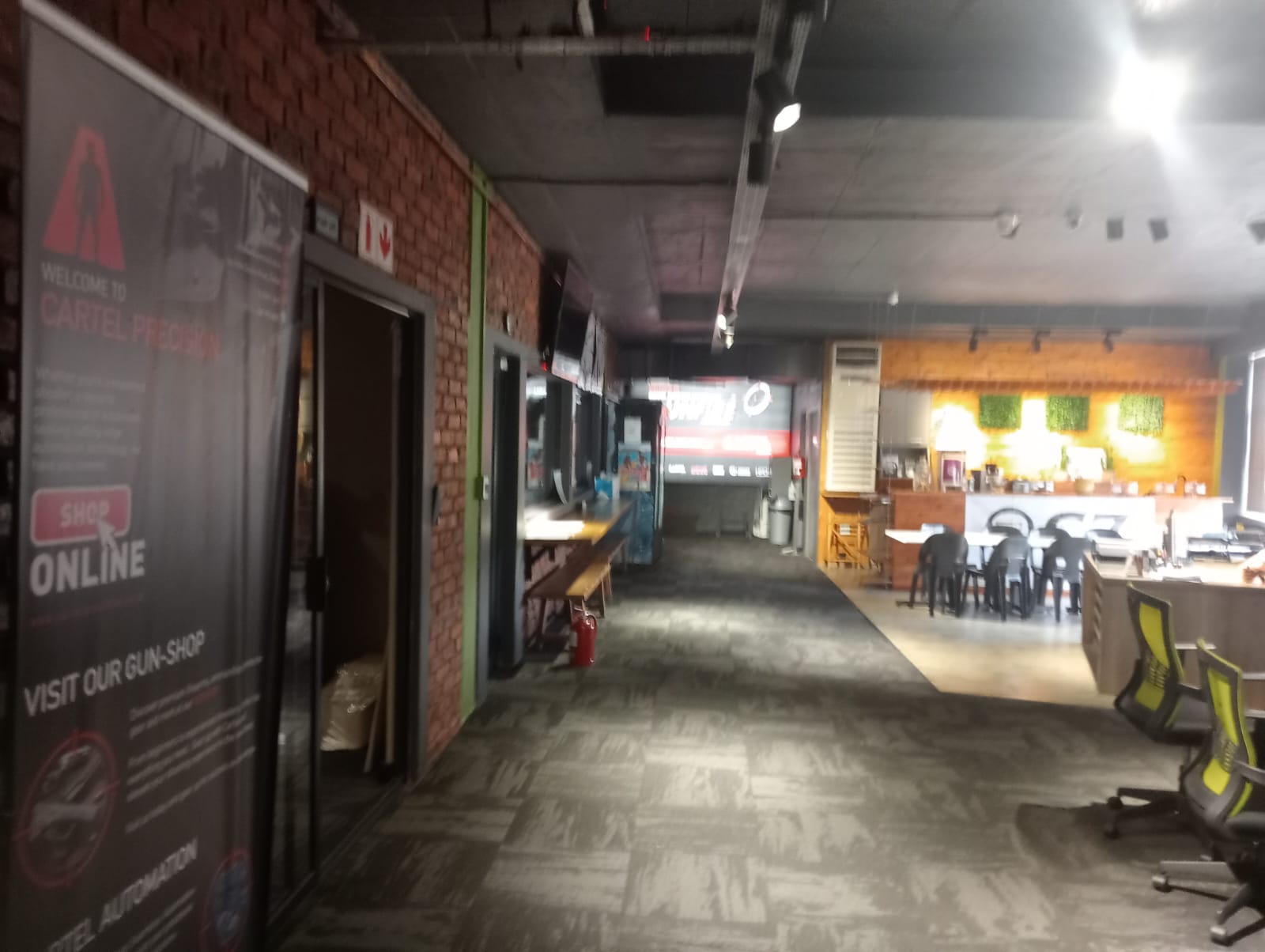 Shop corridor leading towards the GUNFIRE range entrance and coffee bar